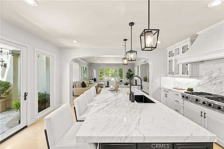 Extended chef's kitchen with marble island at 28 Blue Summit