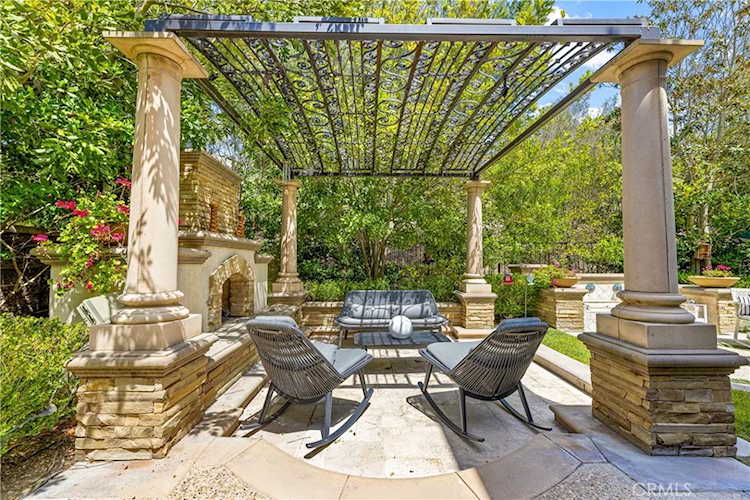 Outdoor fireplace beneath the pergola
